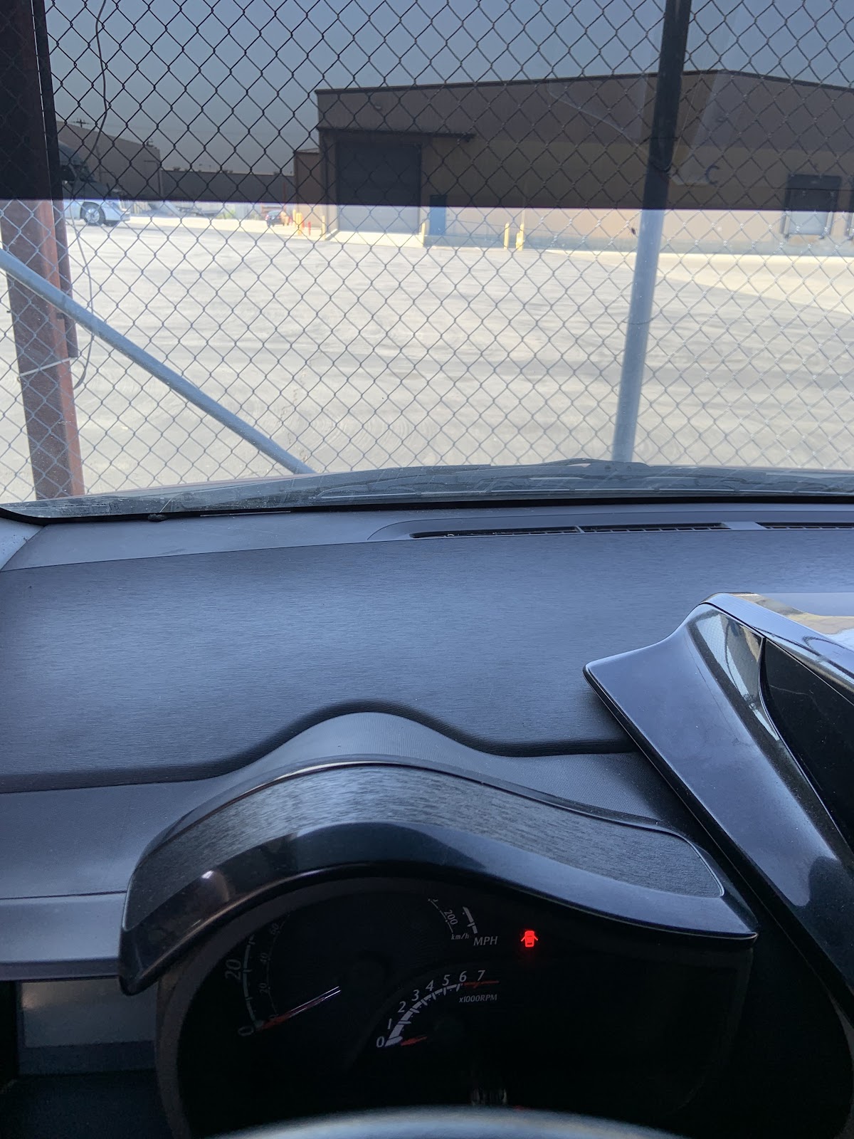 Dust caked across the dash top, air vent, and instrument cluster hood before detailing